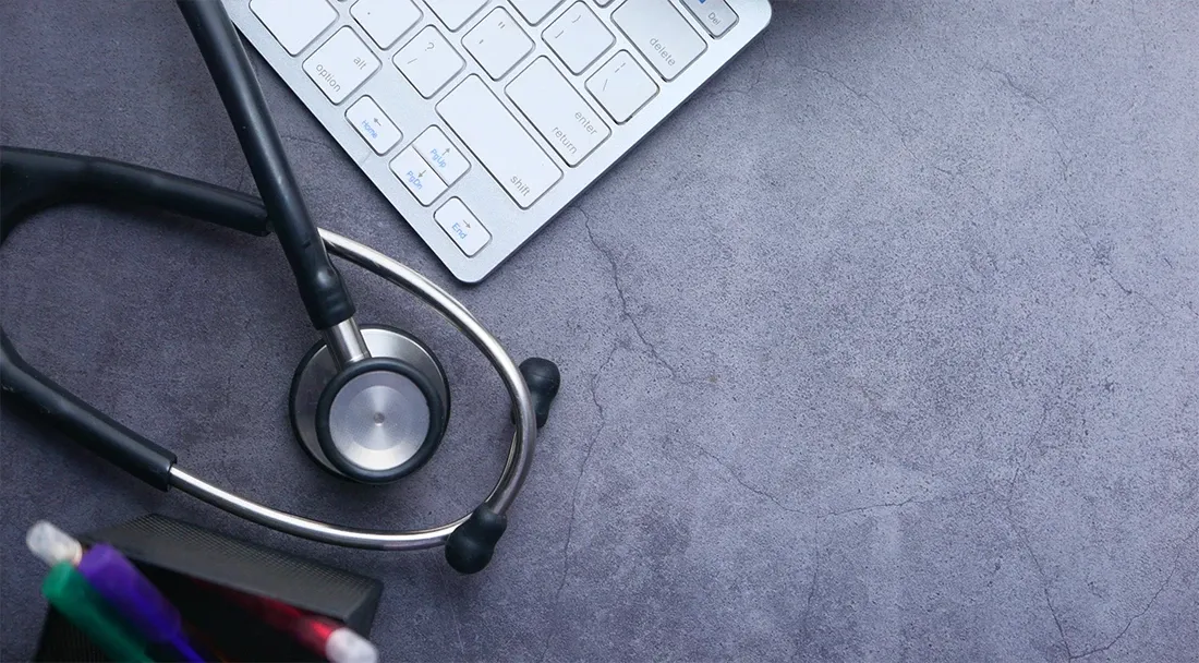 a keyboard, stethescope, and pencils on a table